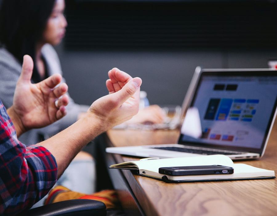 Consultant talking with a client over a laptop