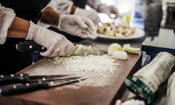 Food handlers in gloves preparing food