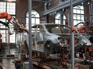 Car body being assembled by robots
