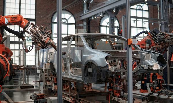 Car body being assembled by robots