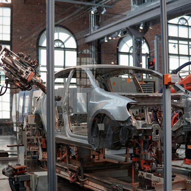 Car body being assembled by robots