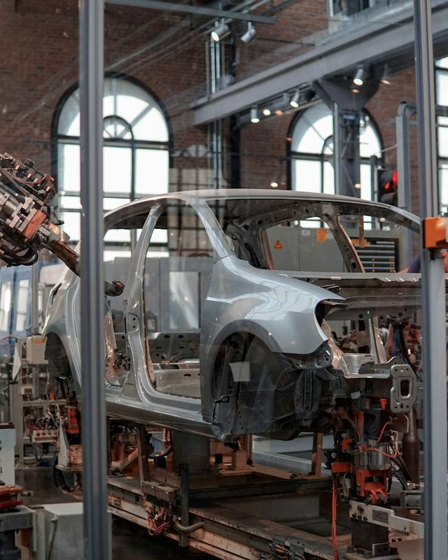 Car body being assembled by robots