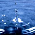 Water drop splashing into water