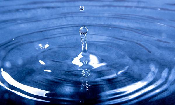 Water drop splashing into water