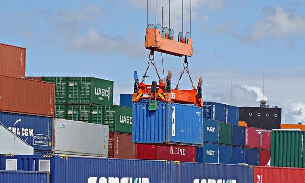 Crane lifting shipping containers at a port