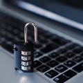 Combination padlock on a laptop keyboard