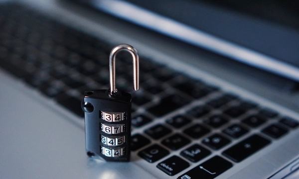 Combination padlock on a laptop keyboard