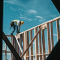 Construction worker in a hard hat on a building frame