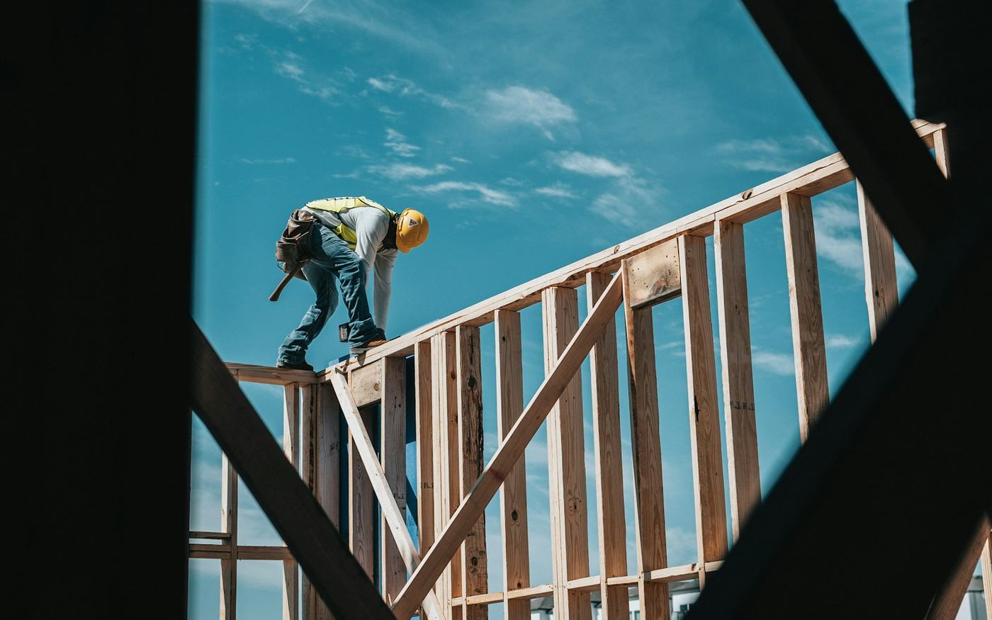 Construction worker in a hard hat on a building frame