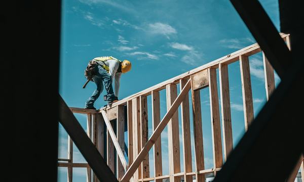 Construction worker in a hard hat on a building frame