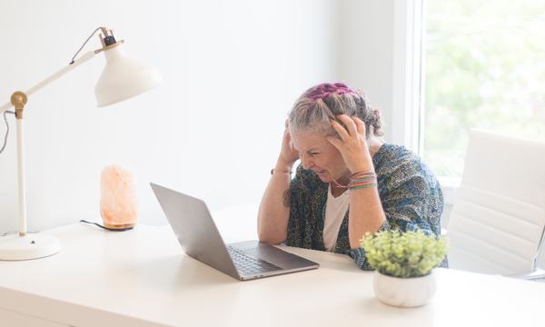 Stressed woman working at a laptop