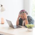 Stressed woman working at a laptop