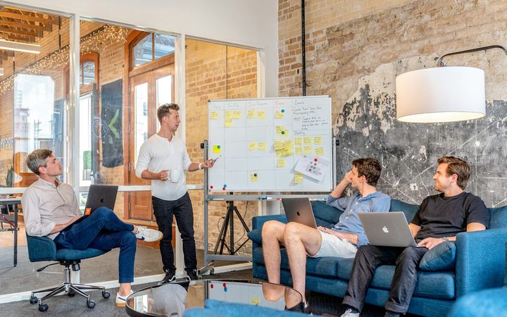 Team meeting in front of a whiteboard
